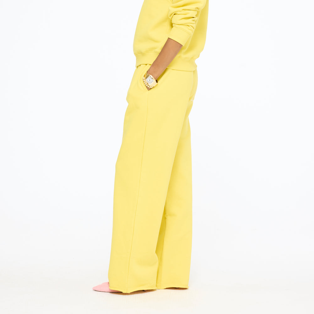 Waist-down side view of the Weekend Barb Sweatpant in washed sunshine yellow