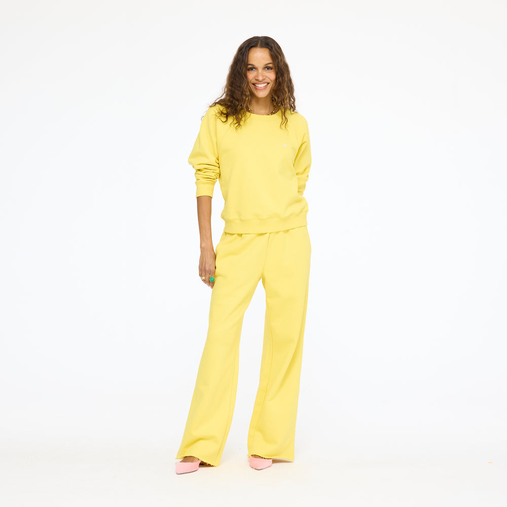 Model wearing the Weekend Barb Sweatpant with a yellow sweatshirt in washed sunshine yellow, full length front view