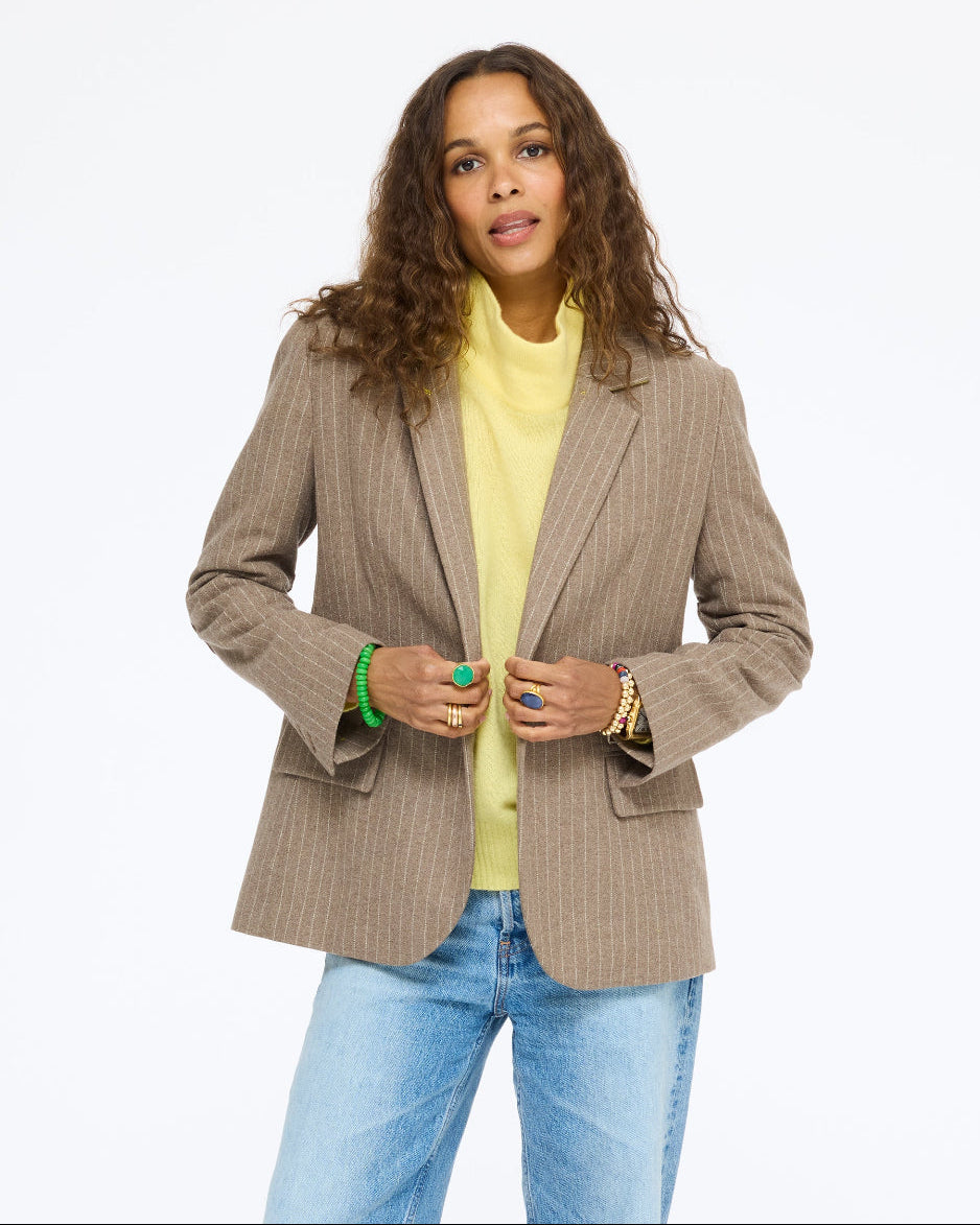 Model wearing the Workday Love Brigade Blazer in taupe pinstripe over the Mad Love Mock Neck Sweater in golden yellow with jeans, front view