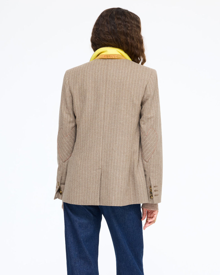 Model wearing the Workday Love Brigade Blazer in taupe pinstripe with jeans, back view