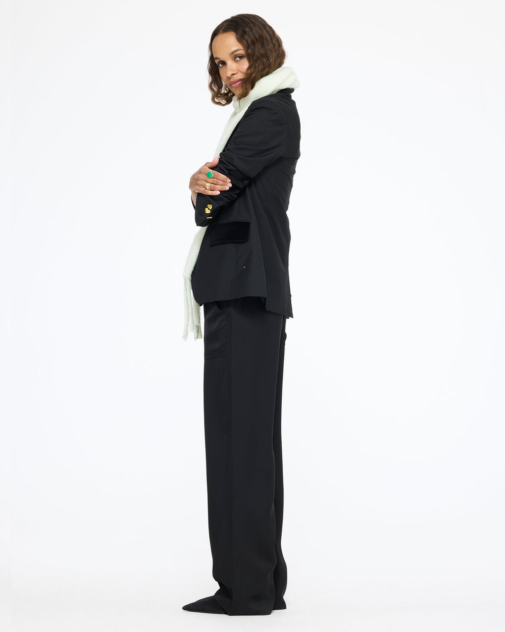 Model wearing the Workday Fancy Blazer in black with black pants, full length side view