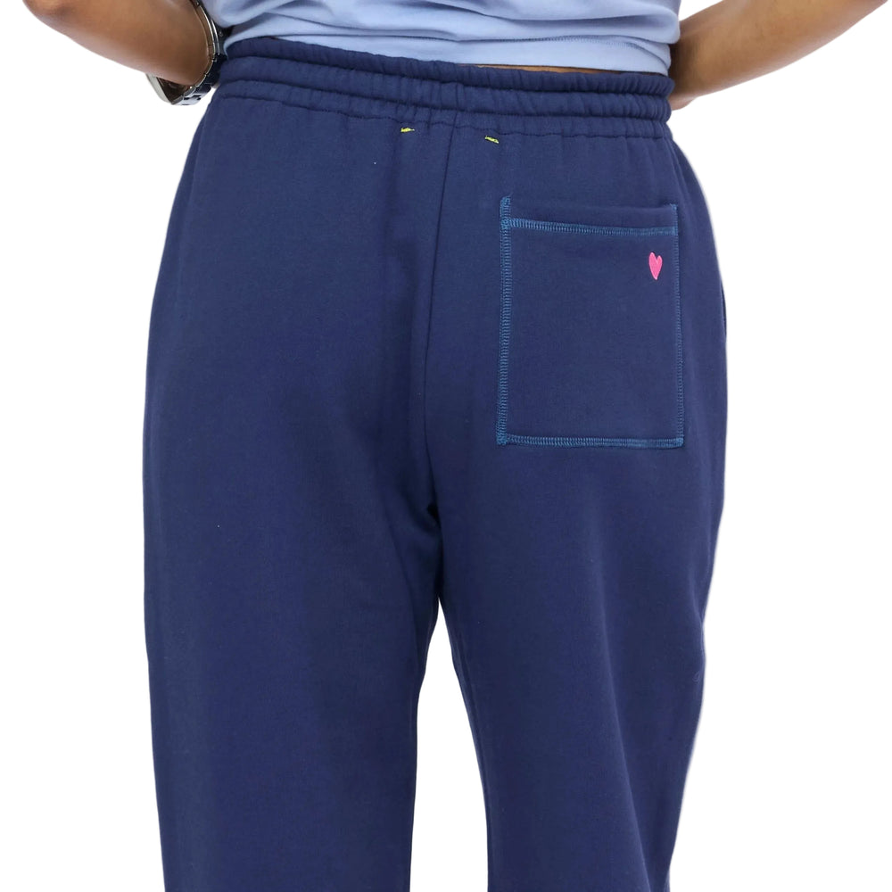 Zommed in back view of woman wearing navy sweatpants. Shop Kerri Rosenthal sweats.