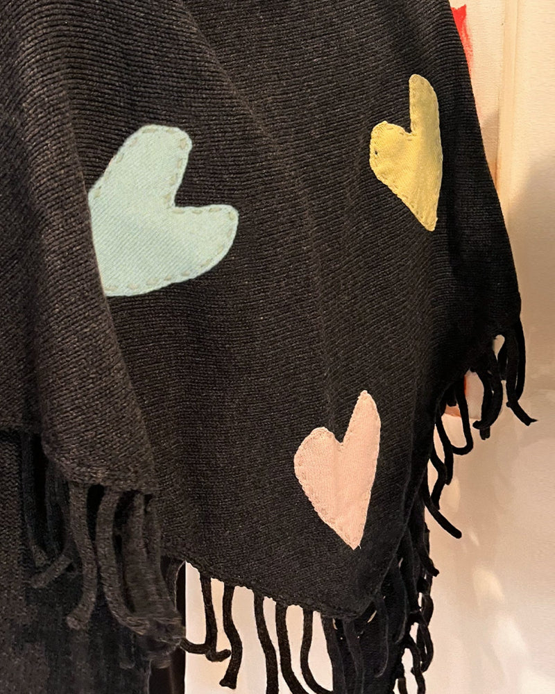 Close-up of the patchwork hearts and fringe on the Love Nest Zero Waste Wrap in black
