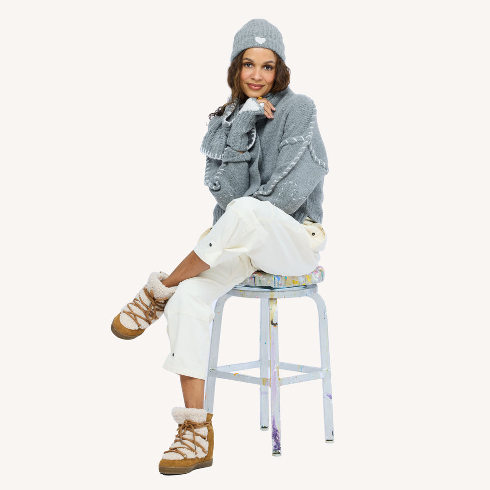 Model wearing grey ribbed Cashmere Beanie paired with Loved Cashmere Smittens and Loved Loop Scarf.