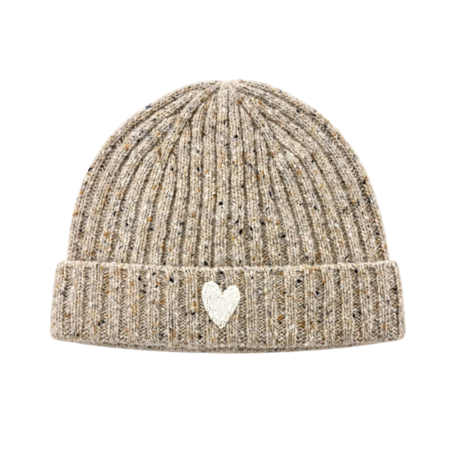 Flat view of the Winter Beanie in oatcake with a ribbed knit, foldover brim, and a small cream heart