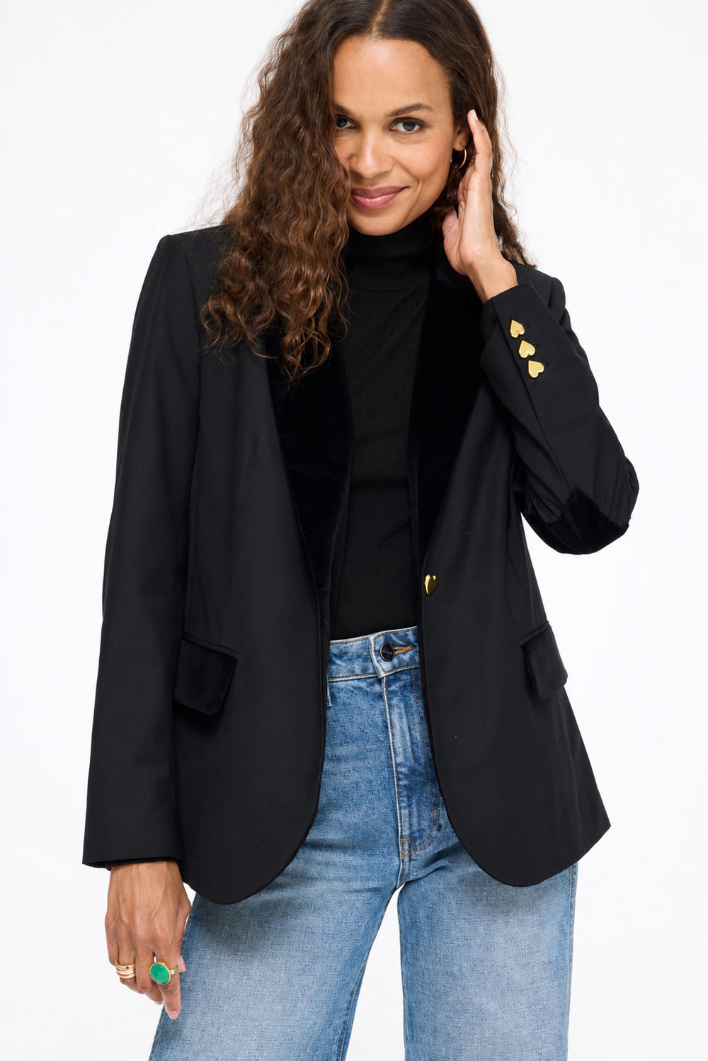 Model wearing the Workday Fancy Blazer in black over the Mock Neck Rib Tee in black with jeans, hand at her collar