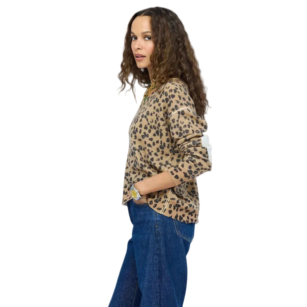 Kerri Rosenthal leopard print top side profile, hand in pocket, paired with jeans
