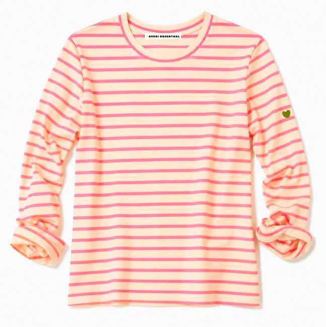Flat lay of a Kerri Rosenthal pink and cream striped long sleeve crewneck top with a small gold heart emblem on the sleeve.