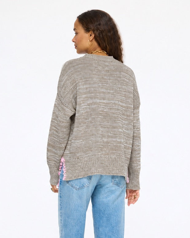 Model wearing the Lovey Heart Pullover in taupe with jeans, back view