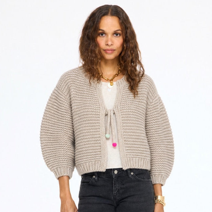 Model wearing the Modern Love Cardigan in taupe tied at the front over a white top with black jeans, front view