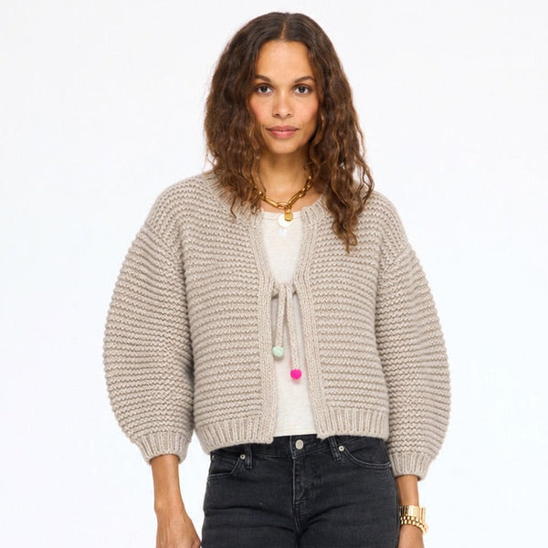 Model wearing the Modern Love Cardigan in taupe tied at the front over a white top with black jeans, front view