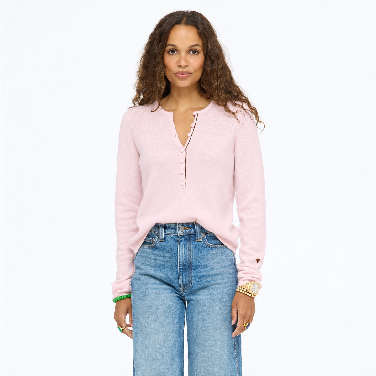 Model wearing the Pixie Sweater in pink with wide-leg jeans, upper body front view