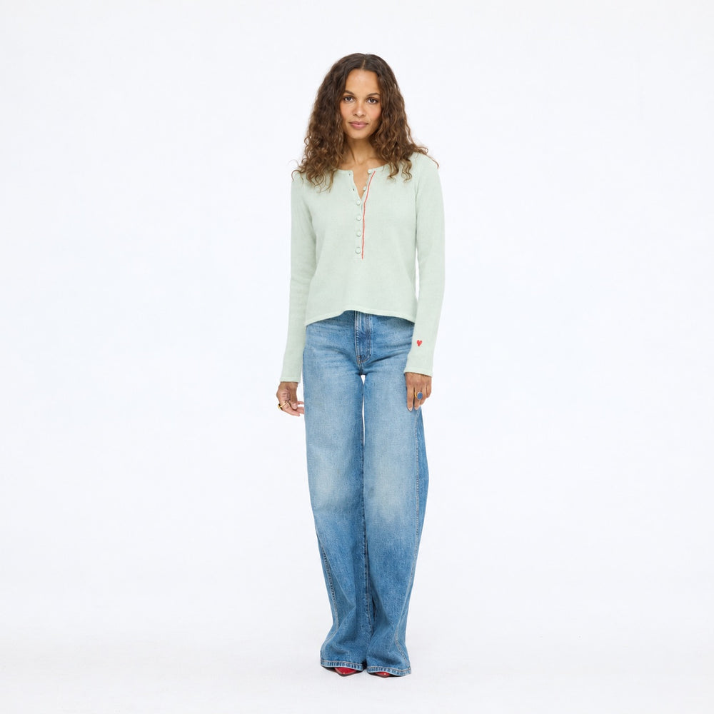 Model wearing the Pixie Sweater in pistachio with wide-leg jeans, full length front view