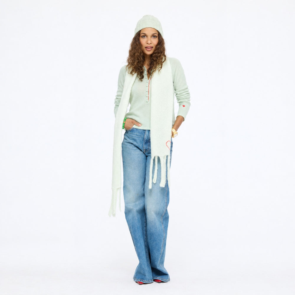 Model wearing the Pixie Sweater in pistachio with the Winter Beanie and Cloud Hopping Scarf in pistachio and wide-leg jeans, full length front view