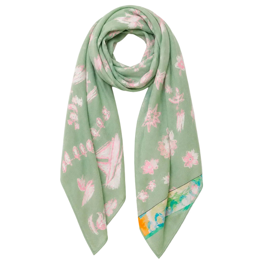 A sage green silk scarf with a pink floral pattern and a multicolor abstract border, displayed on a white background.