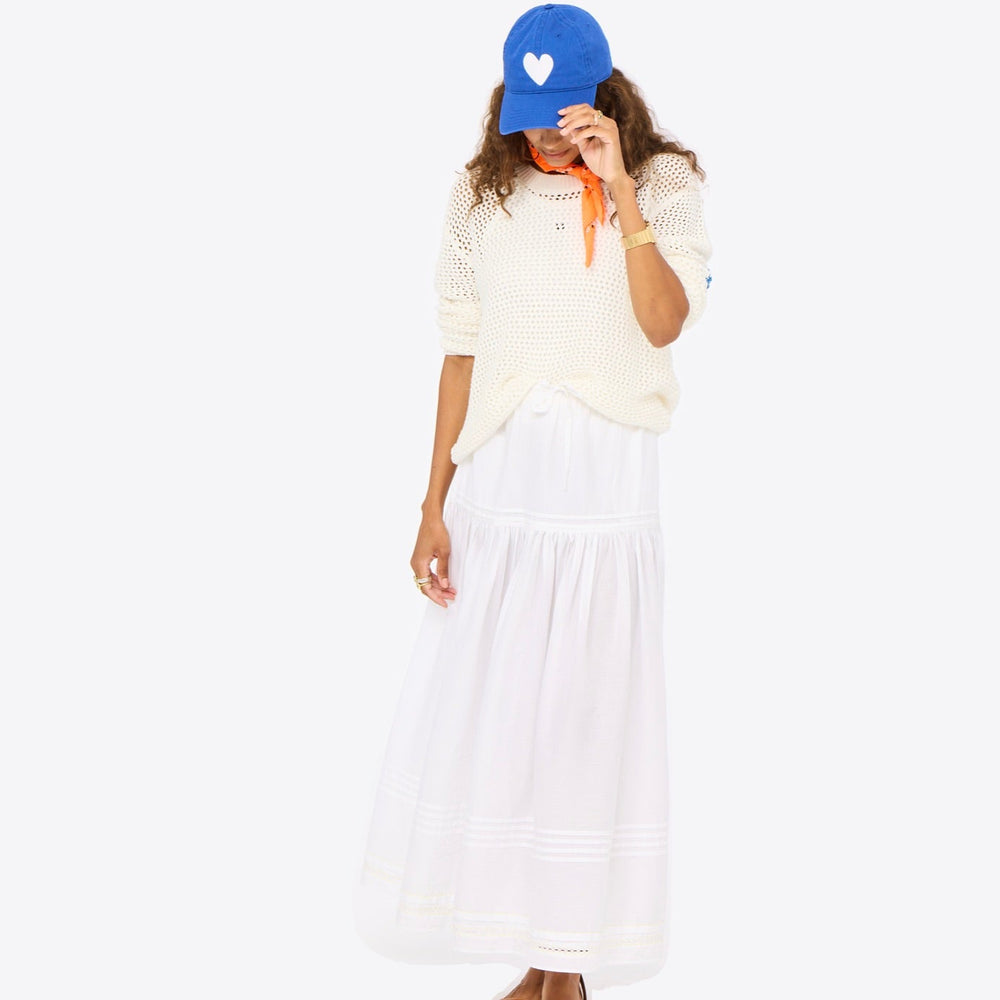 Vacance pintuck white maxi skirt cotton with blue baseball cap hat, white sweater and orange bandana by Kerri Rosenthal