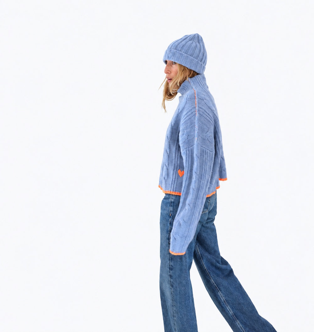 Kerri wearing the Hearth Sweater in blue with the Winter Beanie in blue and jeans, side view
